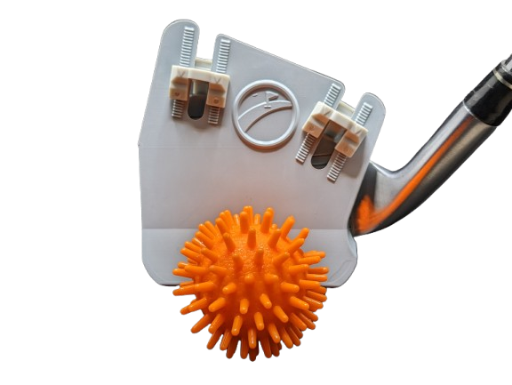 Club Cover with golf iron attached swinging at street golf ball