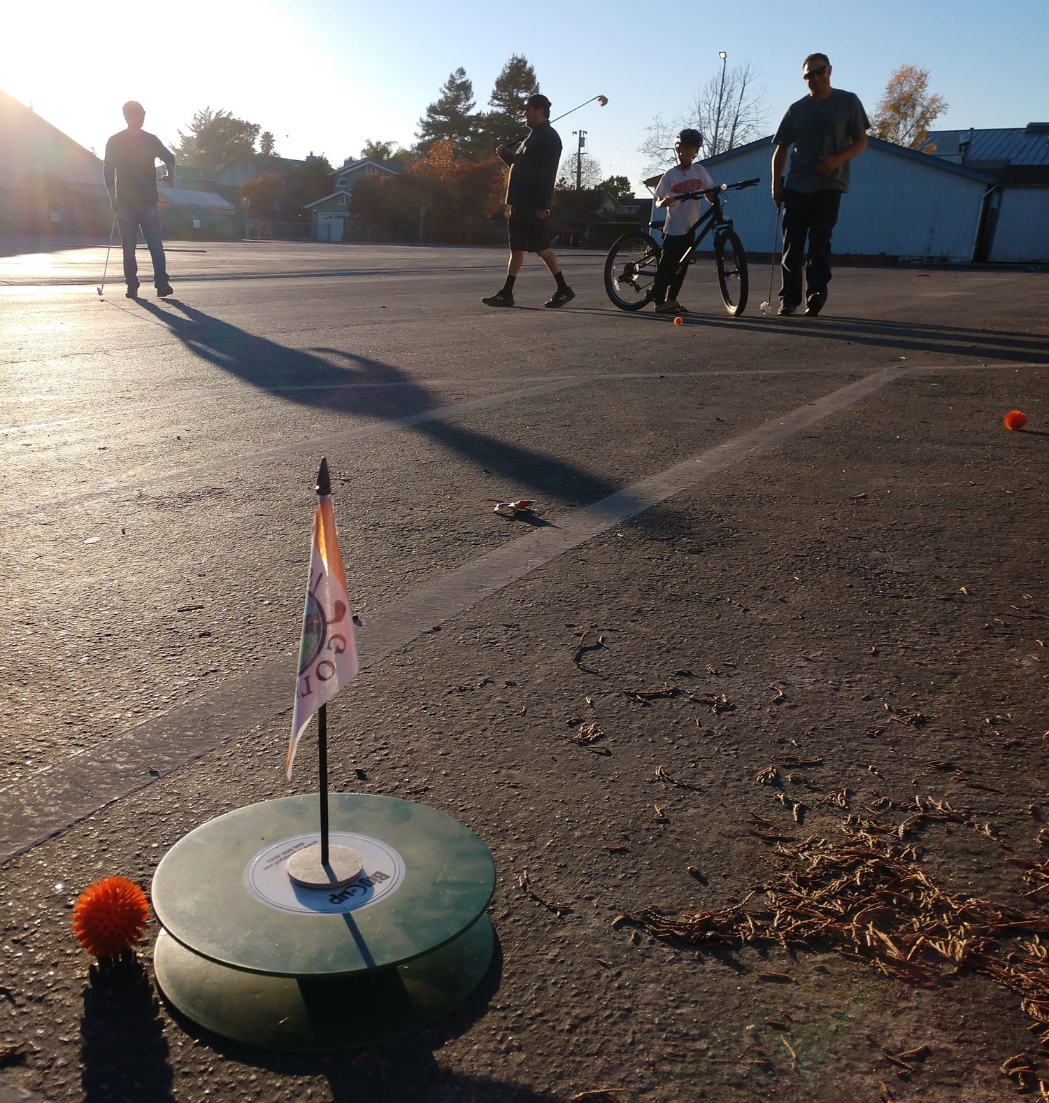 Putting to a Street Golf hole in a parking lot